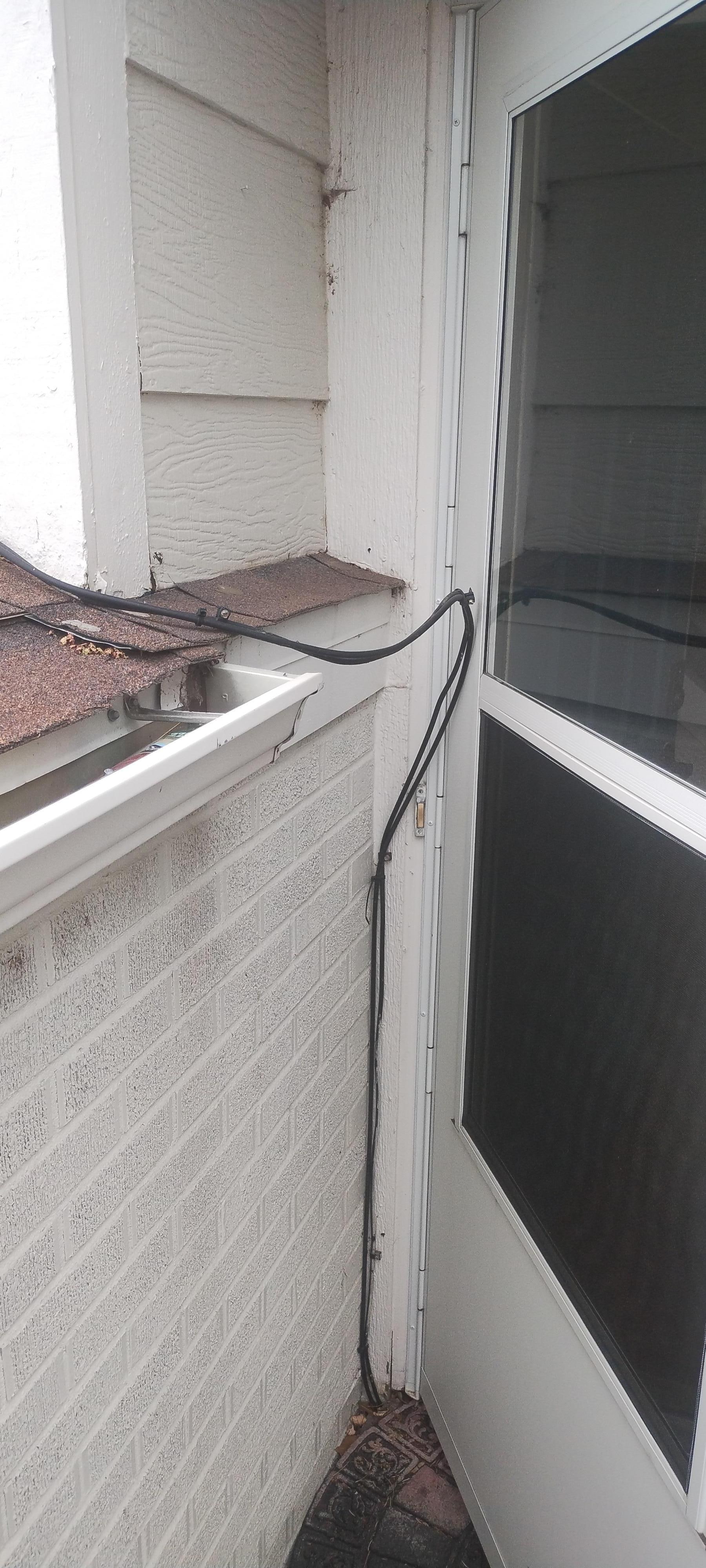 This is the front door with a cable wire making it hard to open and looks terrible.