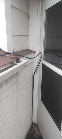 This is the front door with a cable wire making it hard to open and looks terrible.