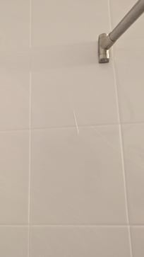 Example of sealant/paint on tile in bathroom shower