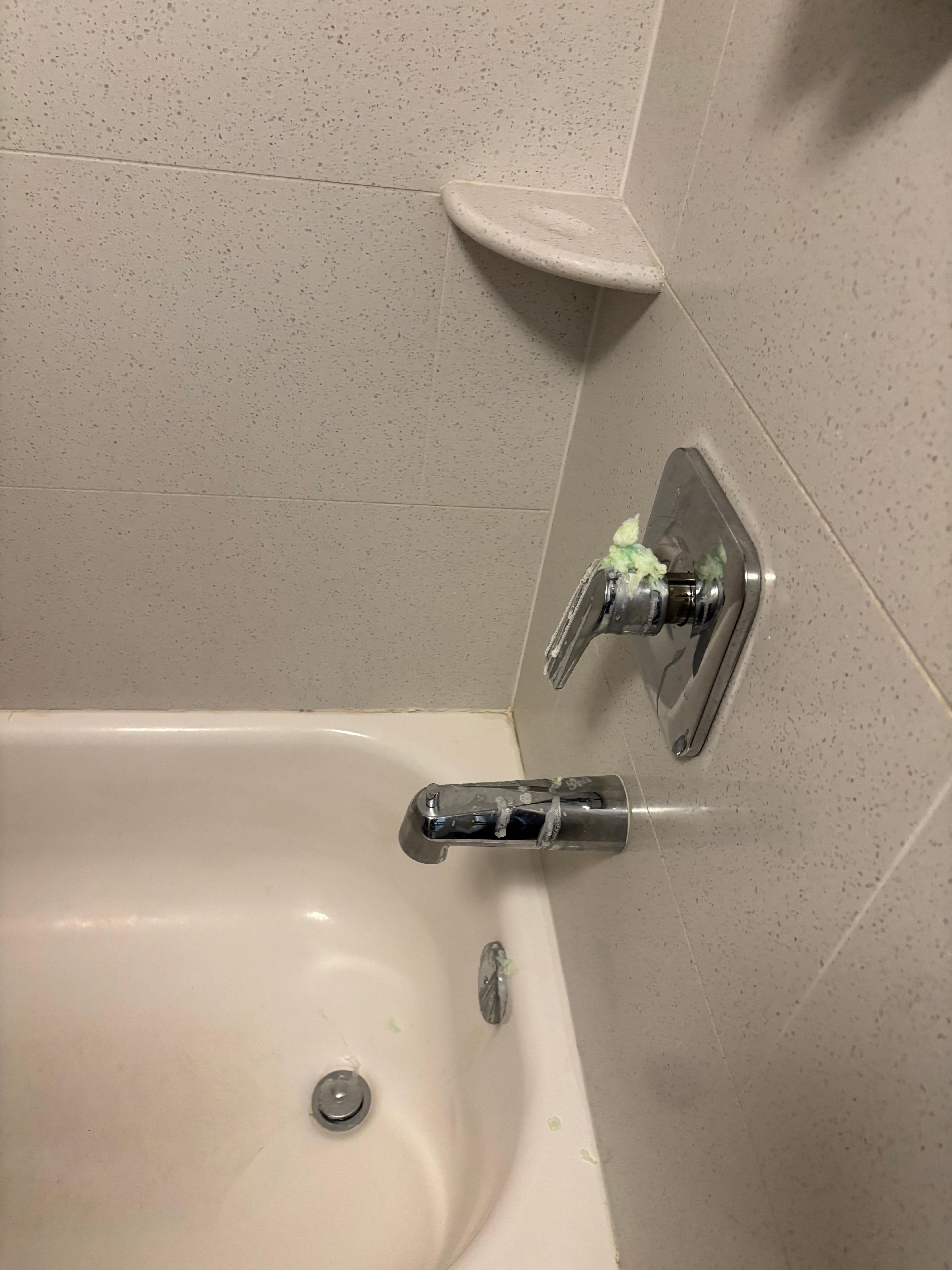 Broken soap dispenser in tub