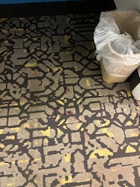 Red stains on carpet.