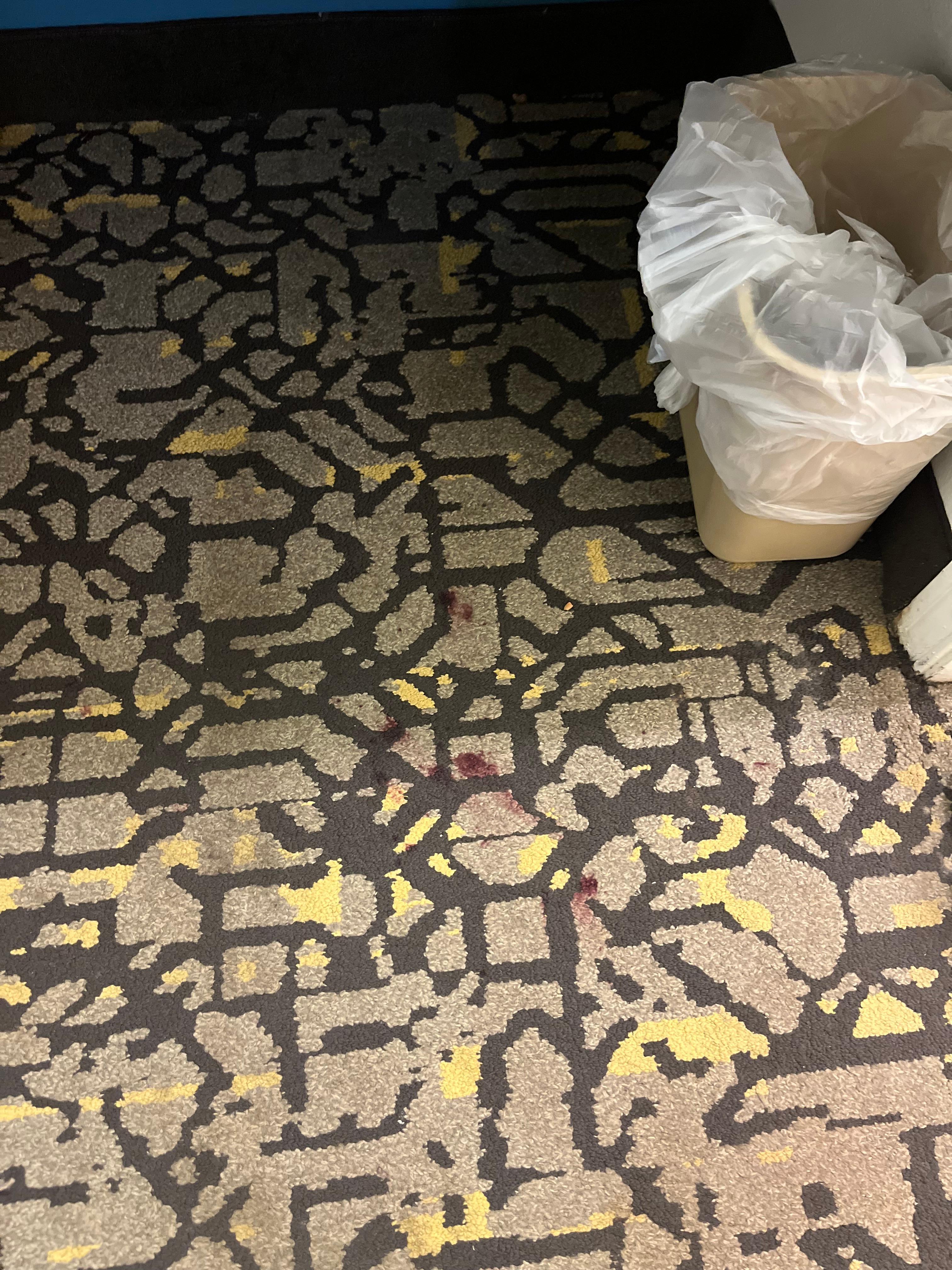 Red stains on carpet.