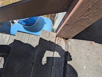 Top stair tread rotted out, safety hazard especially with rotted and loose railing.