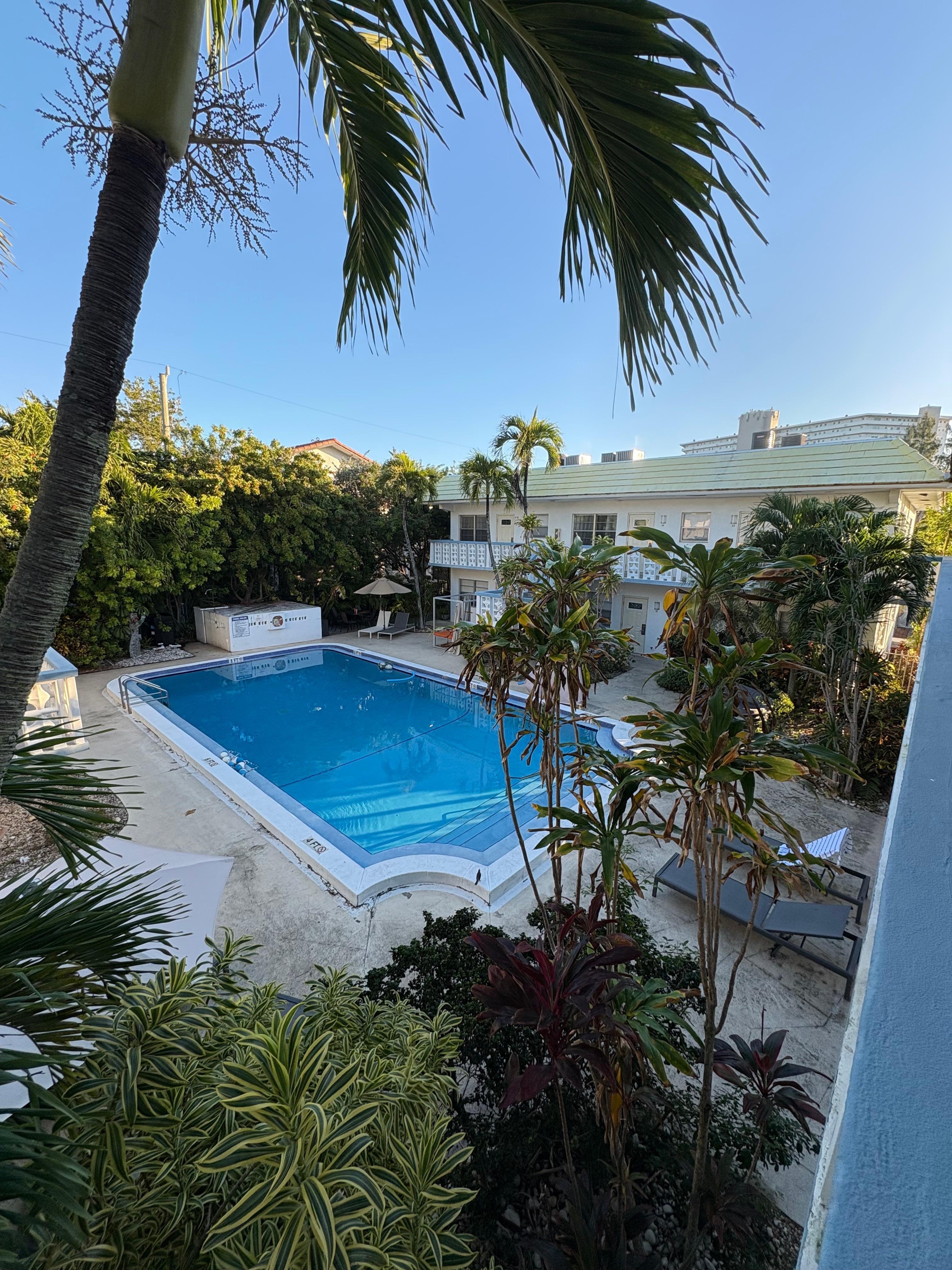 Large, heated pool with plenty of chairs and two cabanas. 