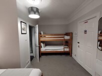 Smoke detector, too close to the bathroom shower, the window inoperable to vent the steam out. 6 am alarm went off by someone upstairs