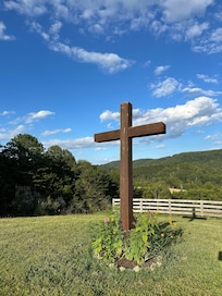 The top of the hill where the big fire pit and swing are.