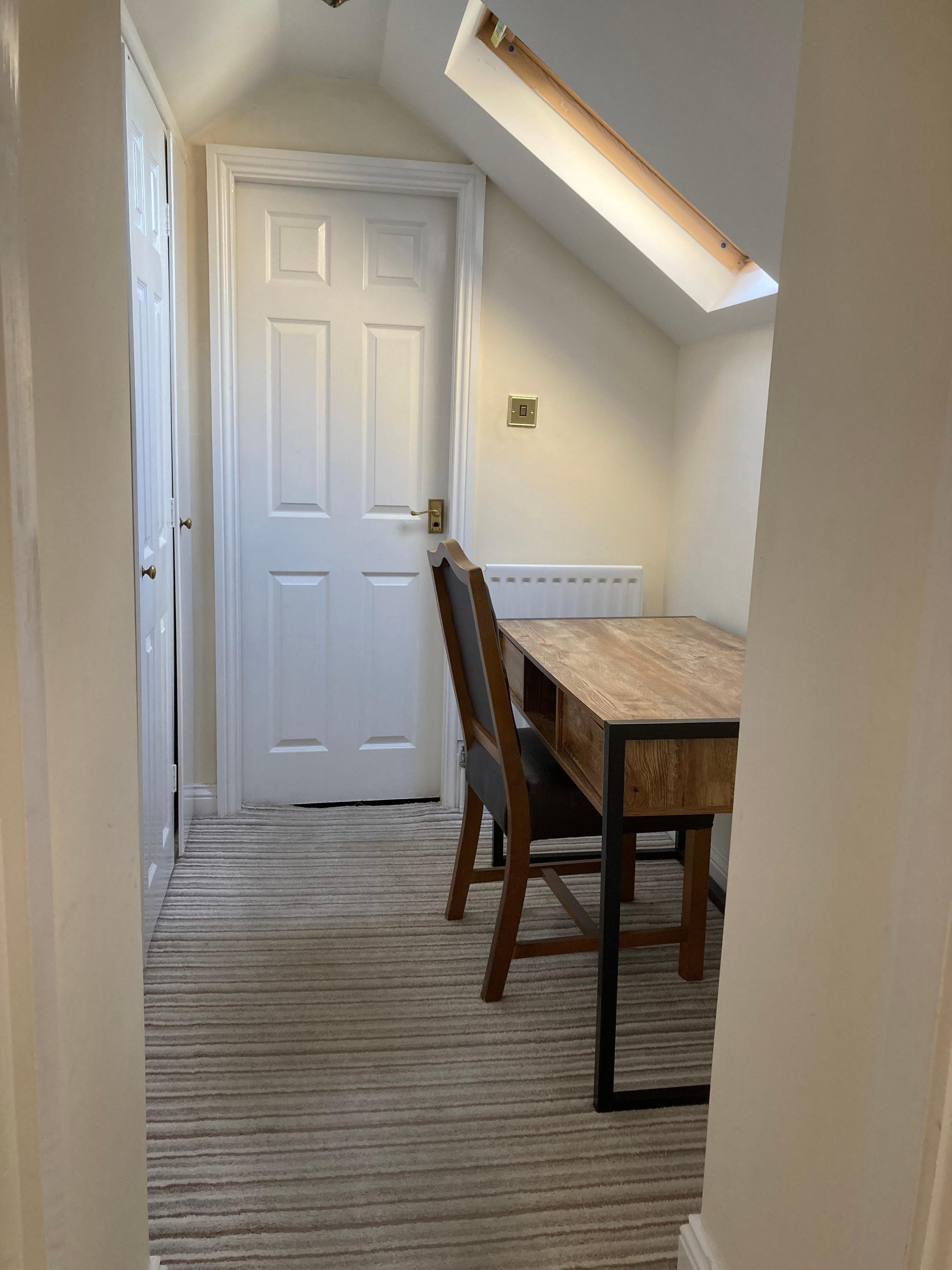 small dressing room/study area between bathroom and bedroom