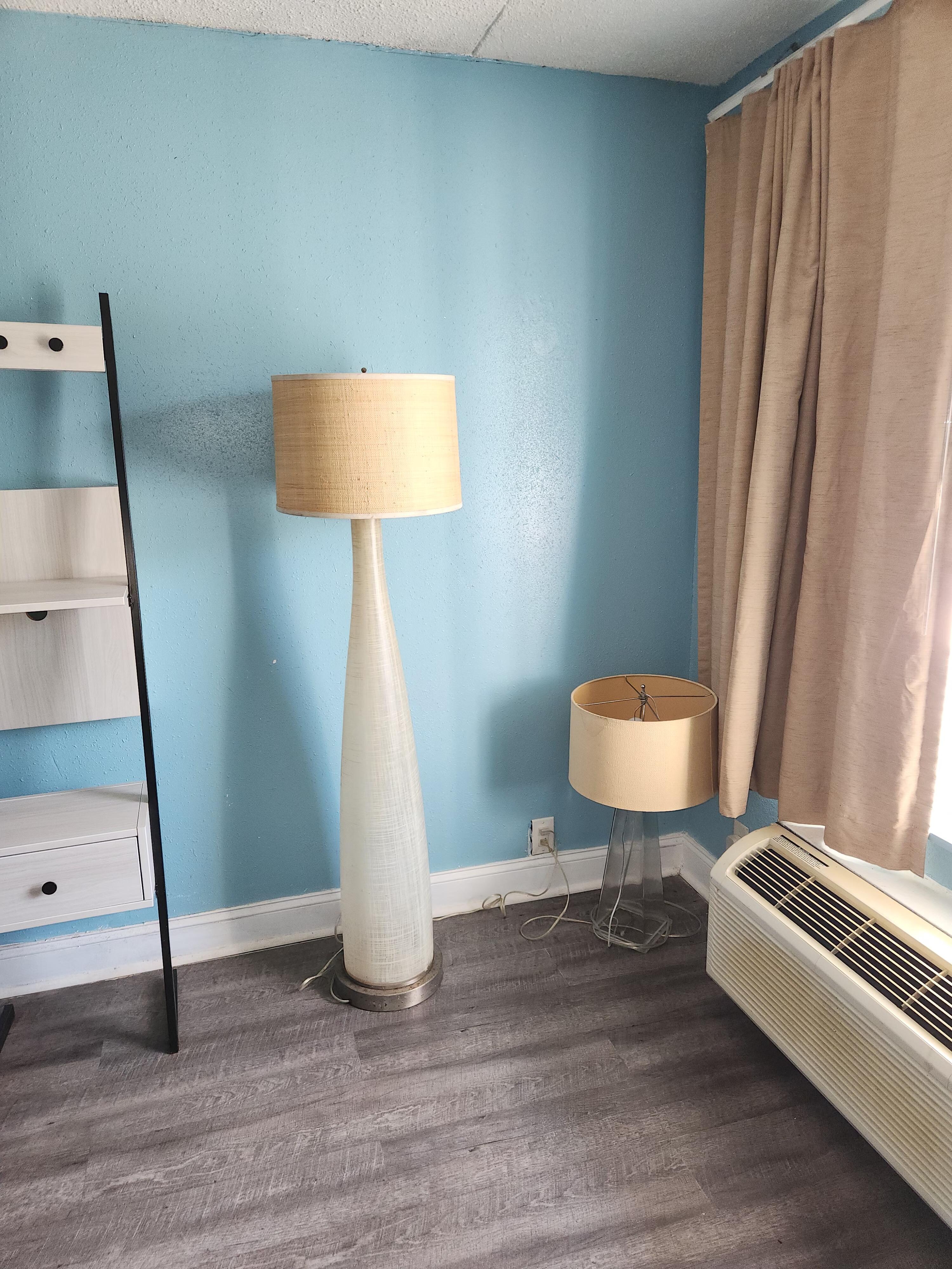 Floor lamp on the floor next to a floor lamp. No side table.