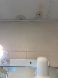 Ceiling above the sink and light fixture