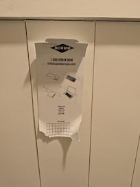 Orkin man instructions for a rodent trap tapped to the wall