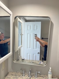 Mirror falling off wall, medicine cabinet peeling