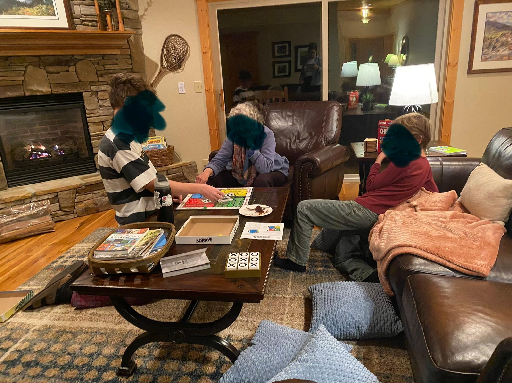 Playing Sorry in the living room (note: no wood needed for gas fireplace! 🙃)