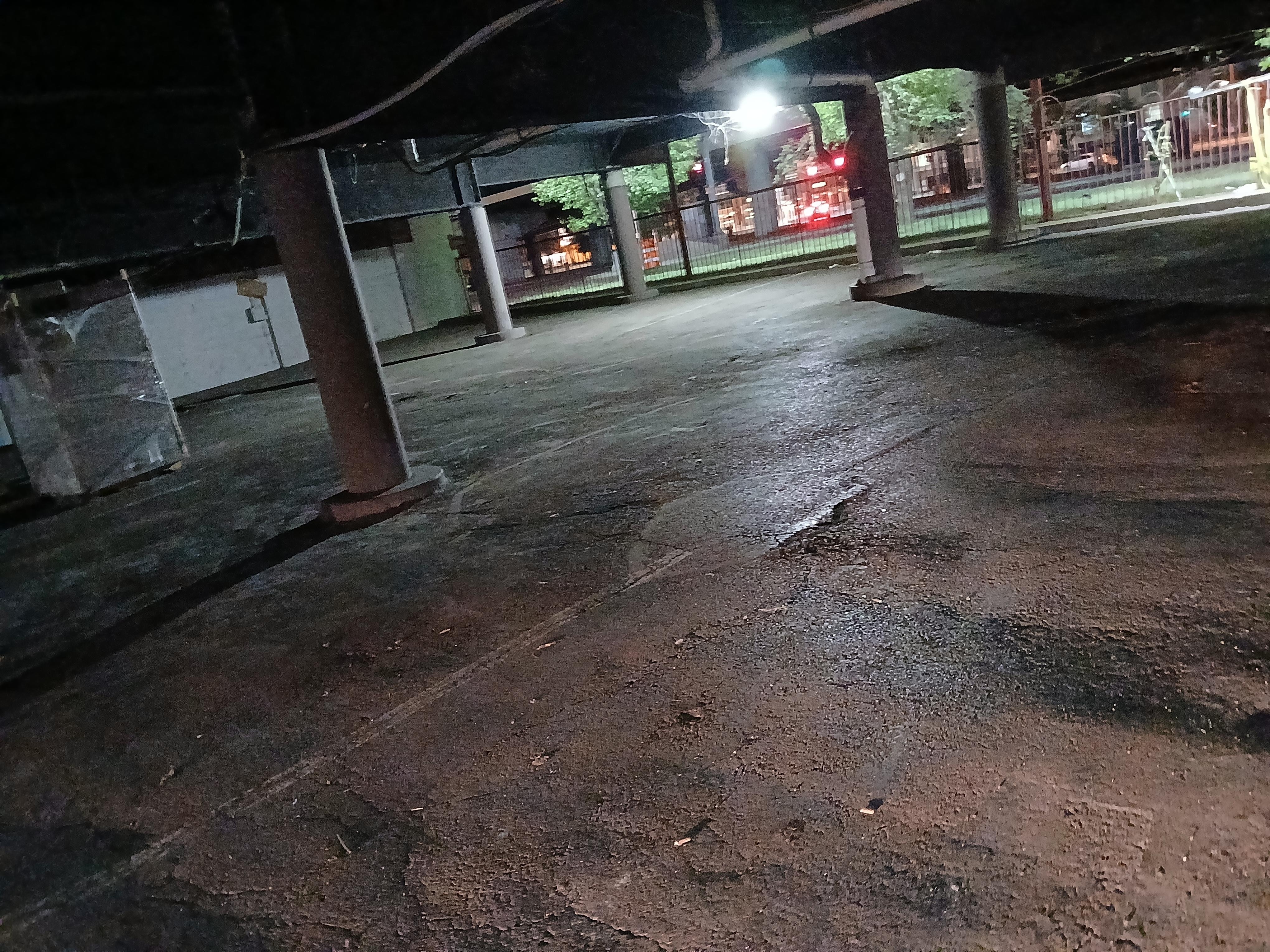 Under building fenced in with barbed wire.  Broken bottles everywhere. 