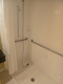 Im 5'8 there was a handheld shower attachment on a stick that kept sliding down & turning to the side spraying the wall. There was zero water pressure. I had to hold the device up with one hand the entire time. Bed was comfortable. Bad smell in