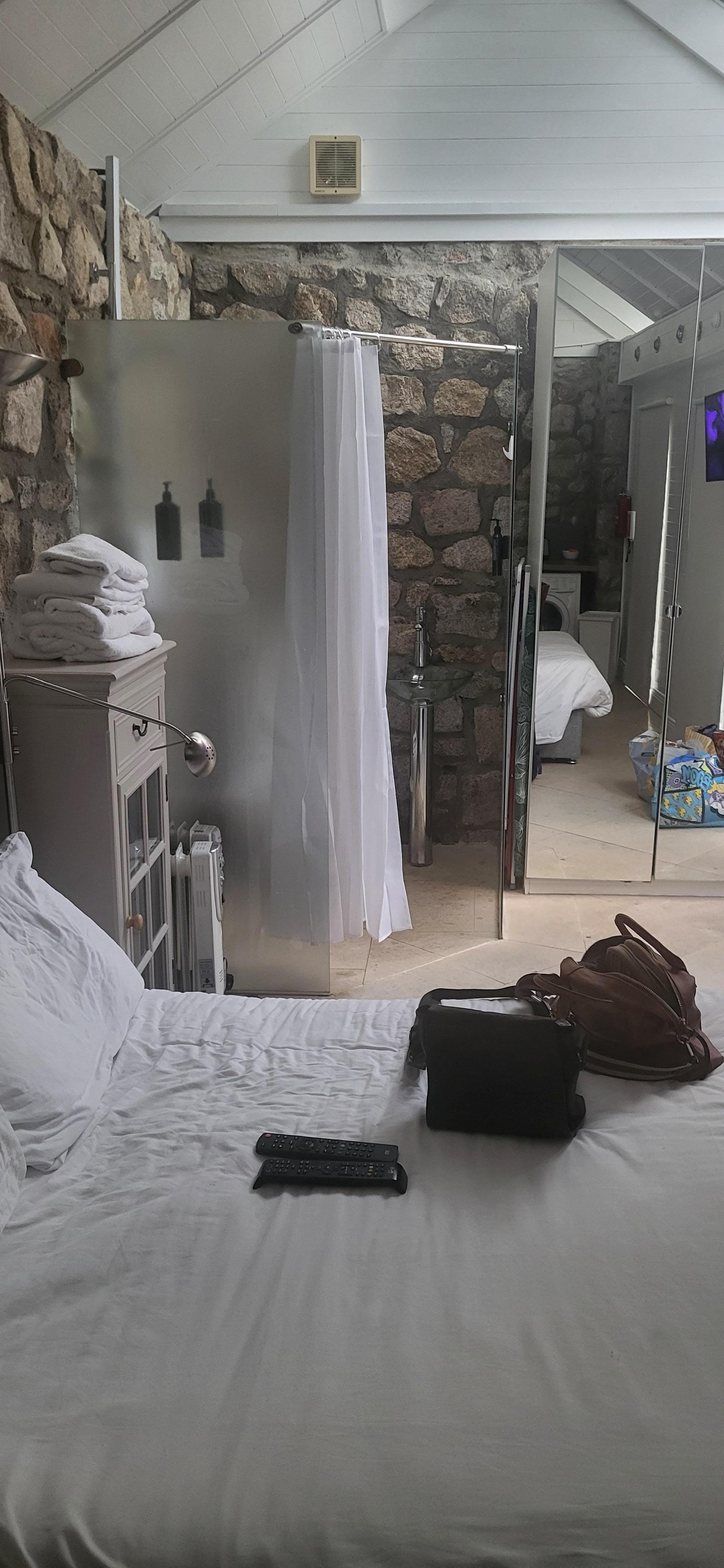 This is a toiet with the shower beside it and it only has a shower cuctain , no door 