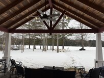 Amazing view of covered patio and lake from inside.