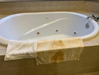 The drained tub and the cleaning towel after 4 rounds of cleaner.