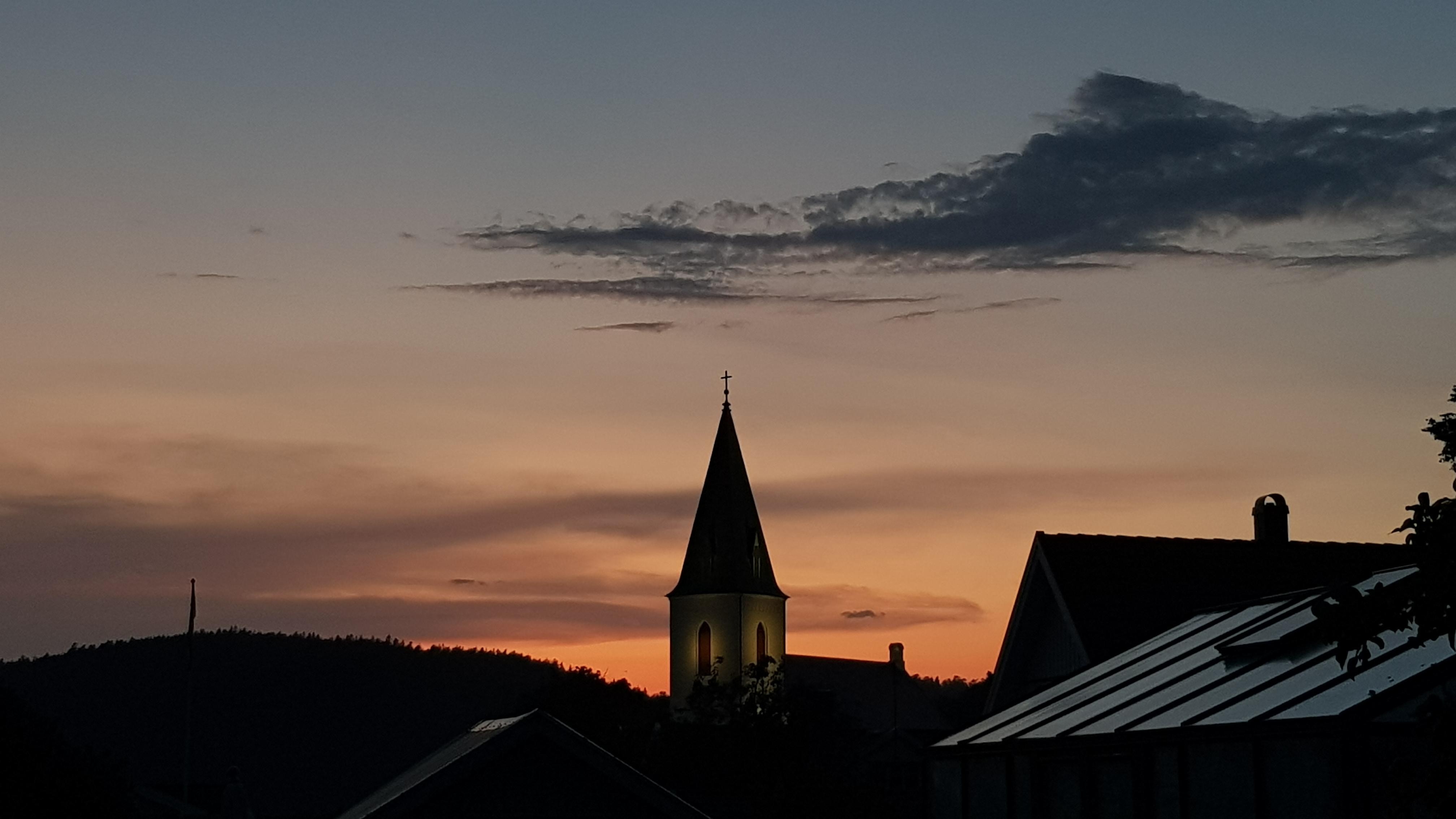 Church in sunset. Seen from the garden