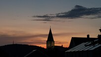 Church in sunset. Seen from the garden