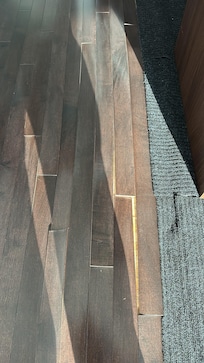 Floors buckling by the kitchen island. I continually tripped over it. This would render the apartment useable for people with movement issues.