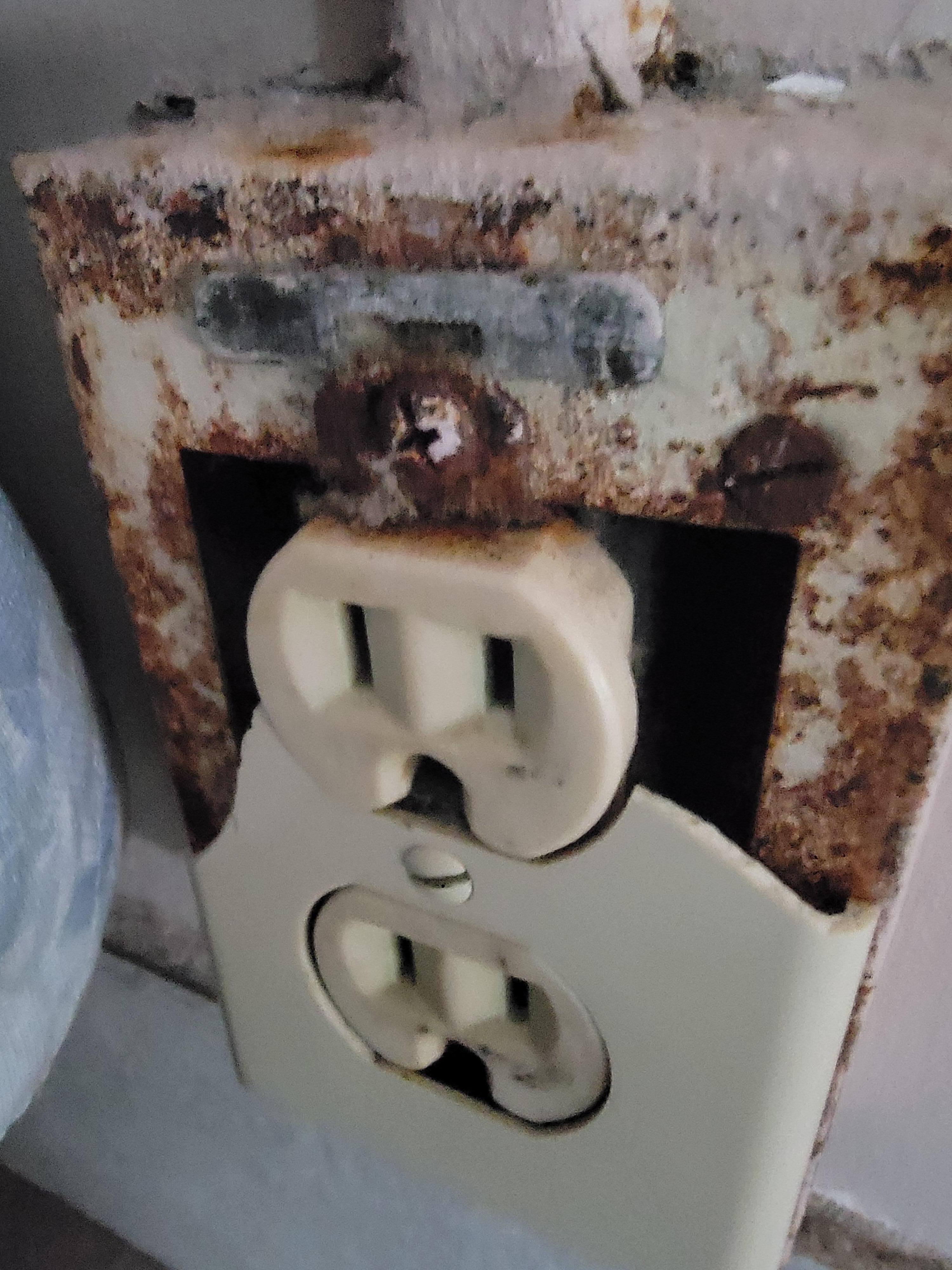 Wall socket broken rusty and moldy