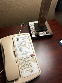 stained, disconnected phone and corroded lamp