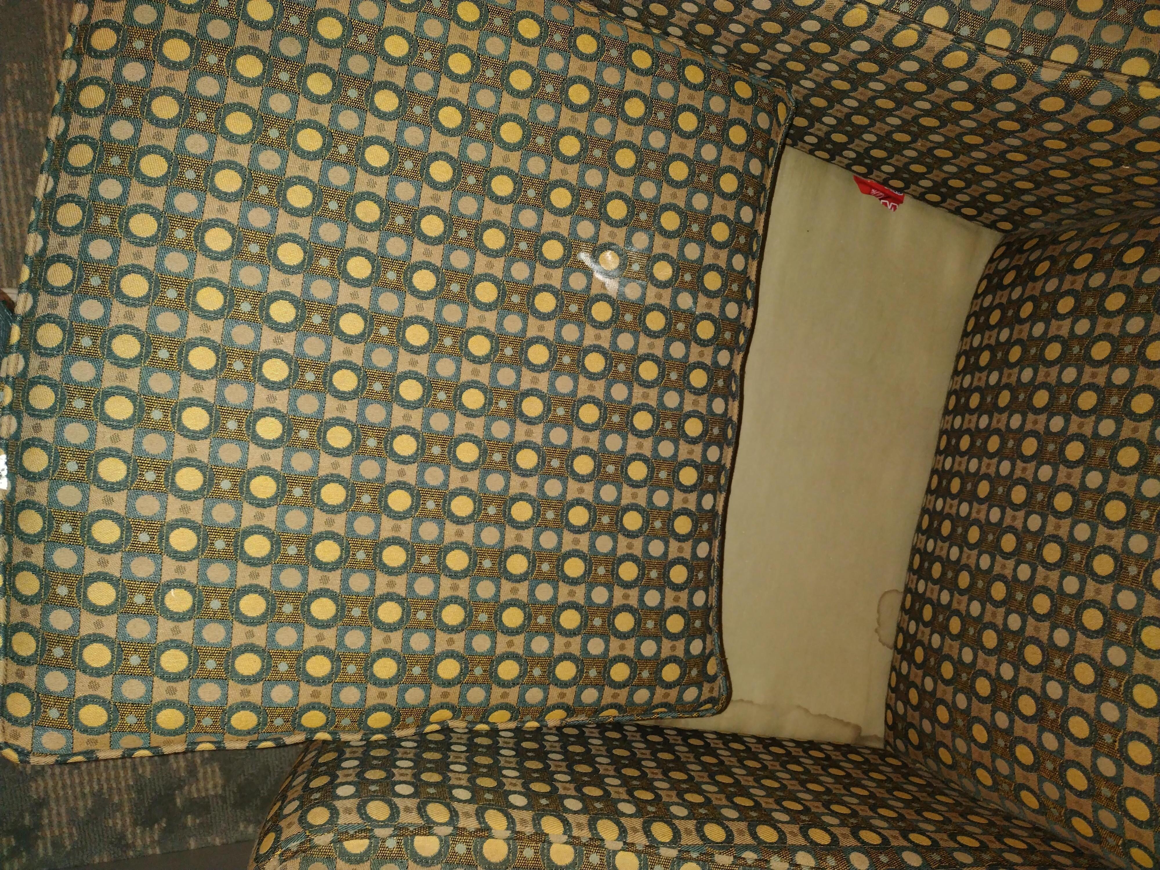 Stained chair with white chunky stuff and stained wet spots on the sides of the I side under part of the chair. 