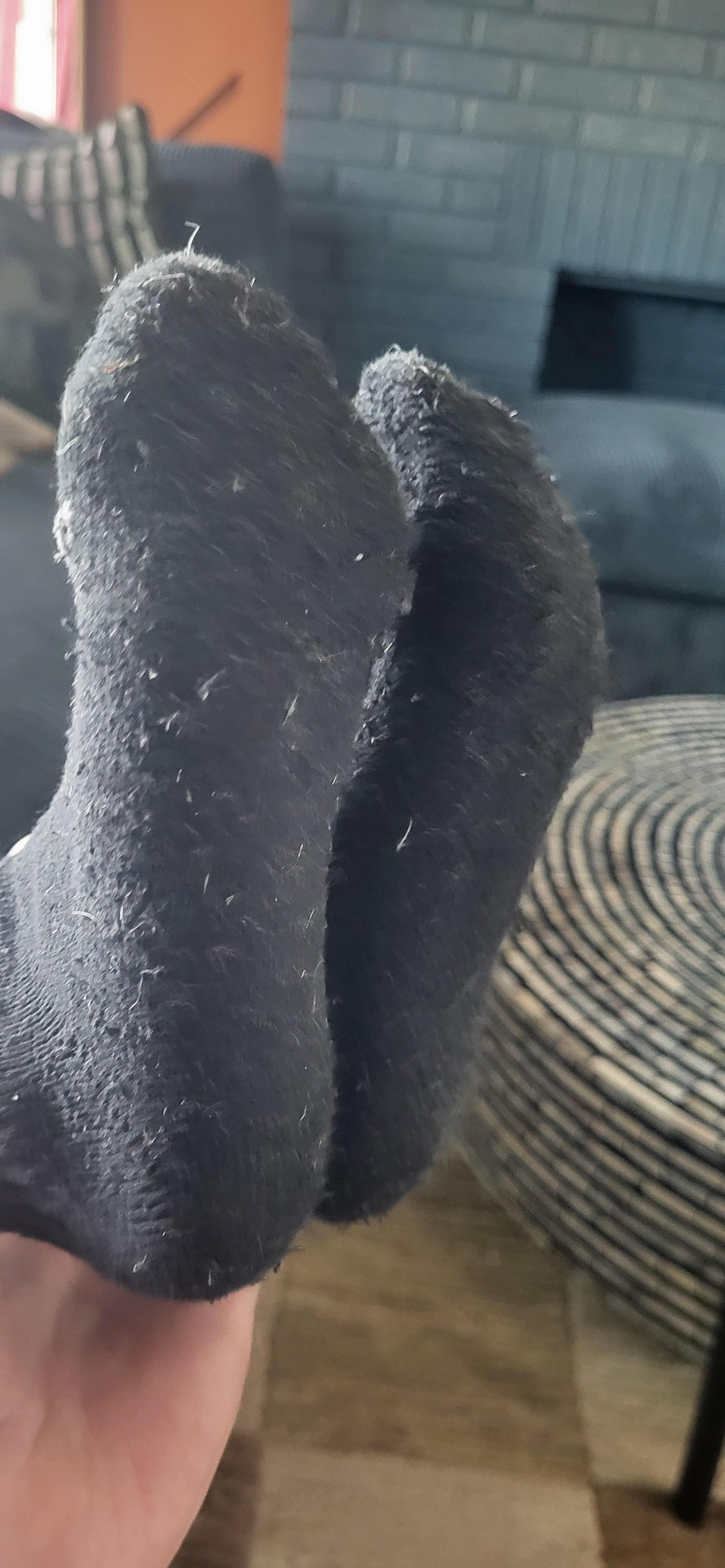 5 year old daughters feet wearing brand new black socks just from walking in 