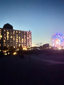 Night view of hotel and Ferris wheel view from beach