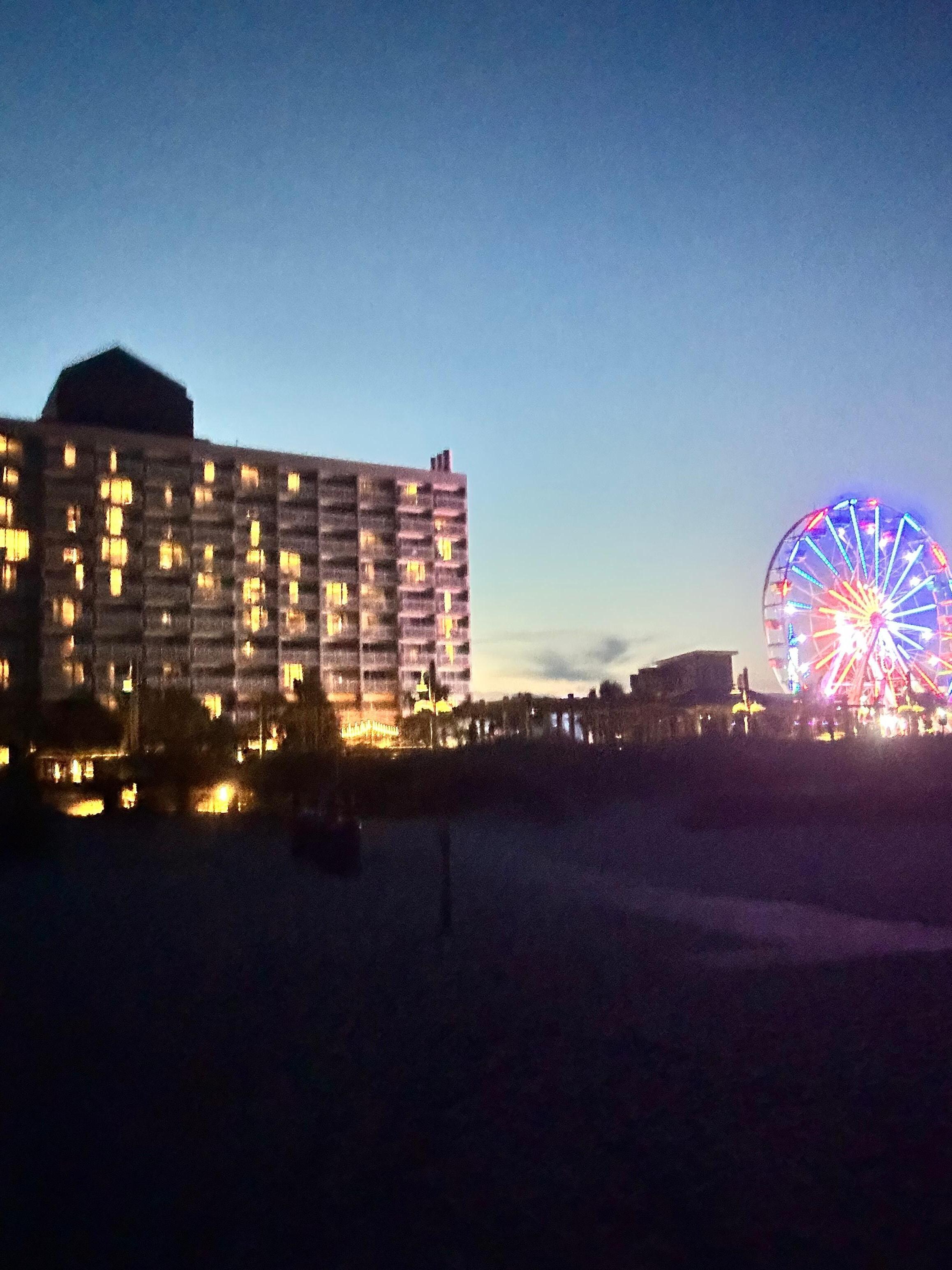 Night view of hotel and Ferris wheel view from beach
