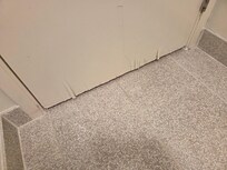 Frayed door frame in bathroom.