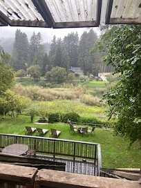 View from upper covered porch with plenty of seating and a picnic table for outdoor dining
