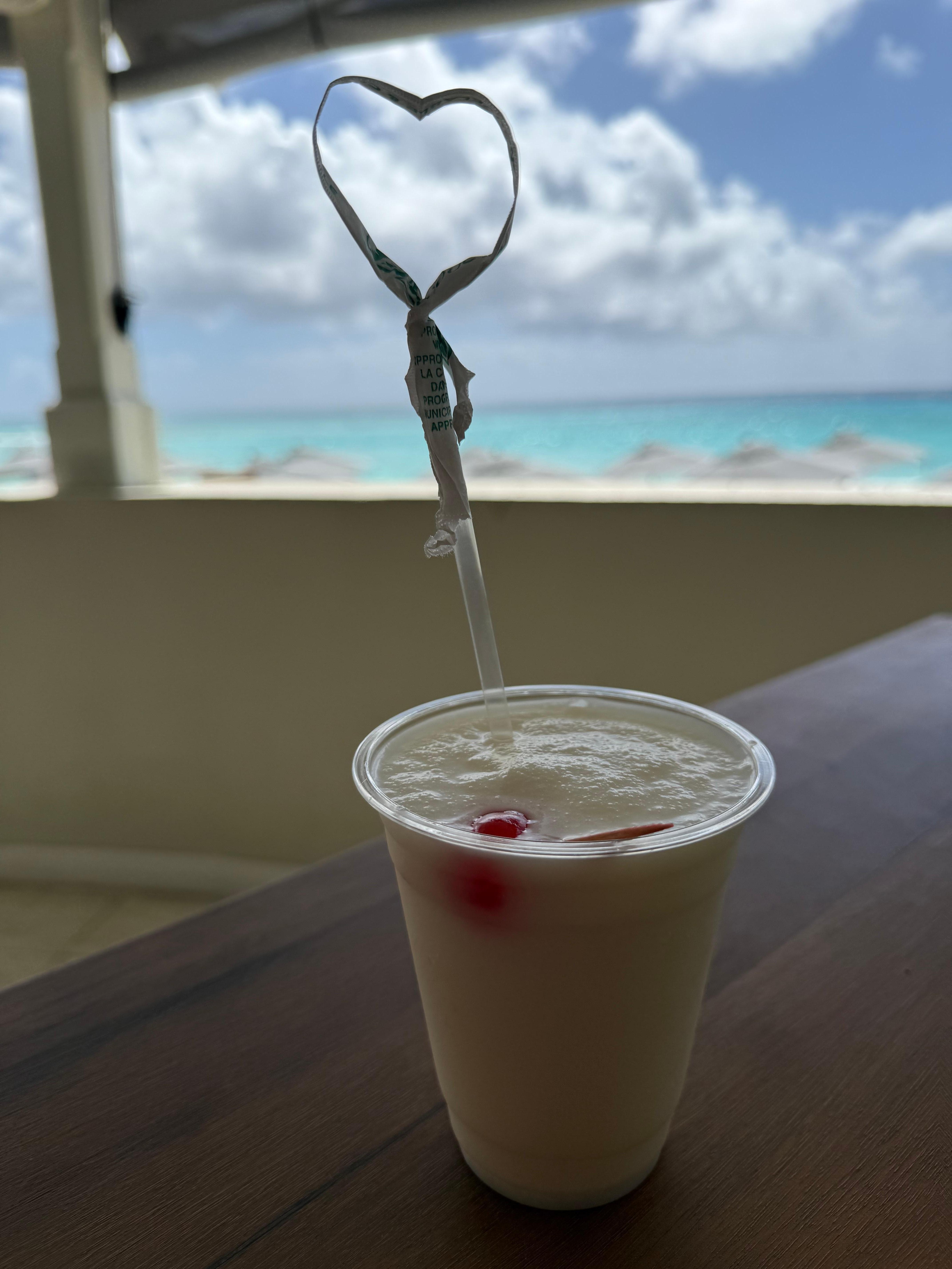 View of the beach while sitting in the restaurant drinking a piña colada