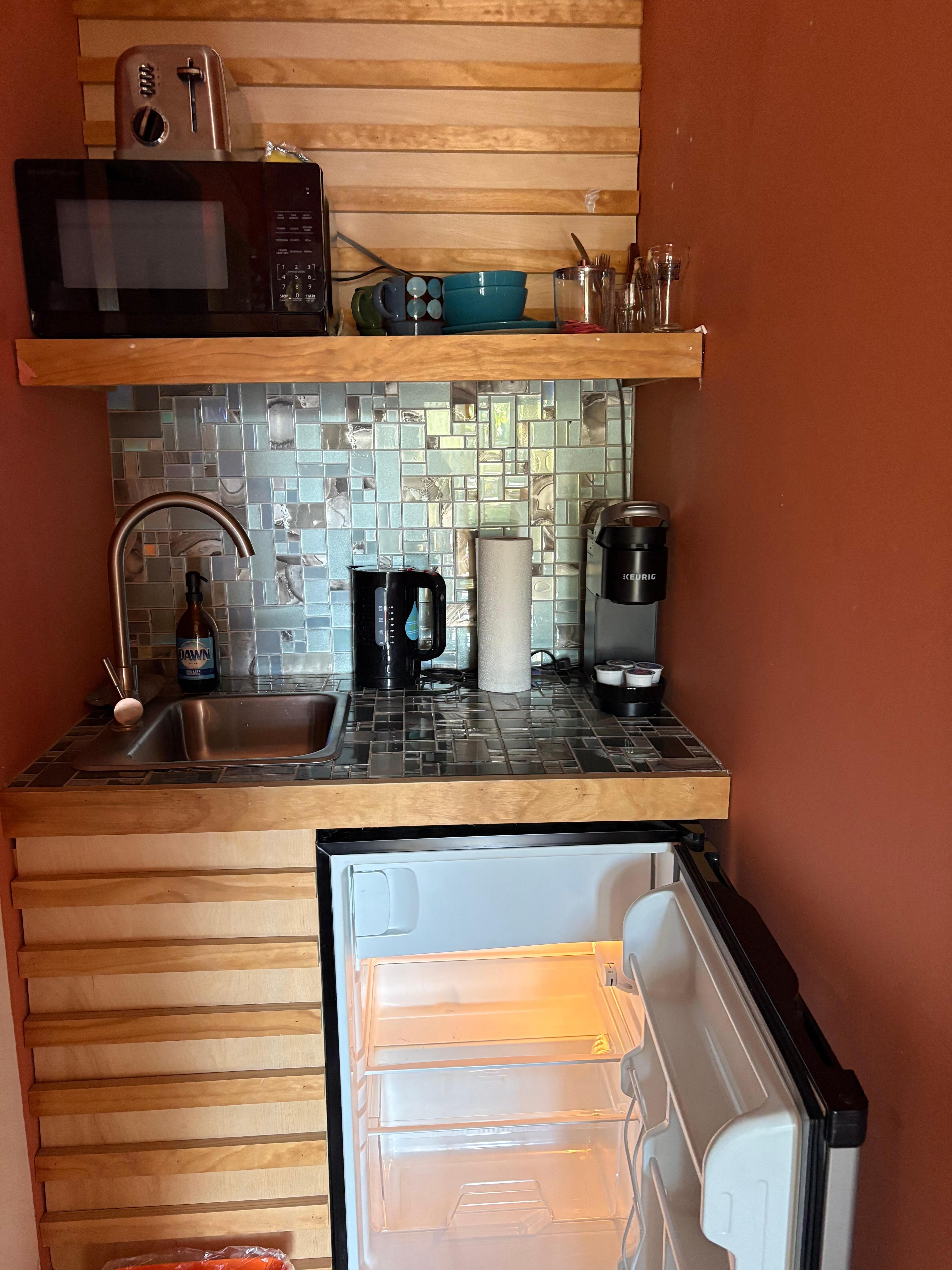 Kitchenette near the bathroom, outside of the bedroom. 