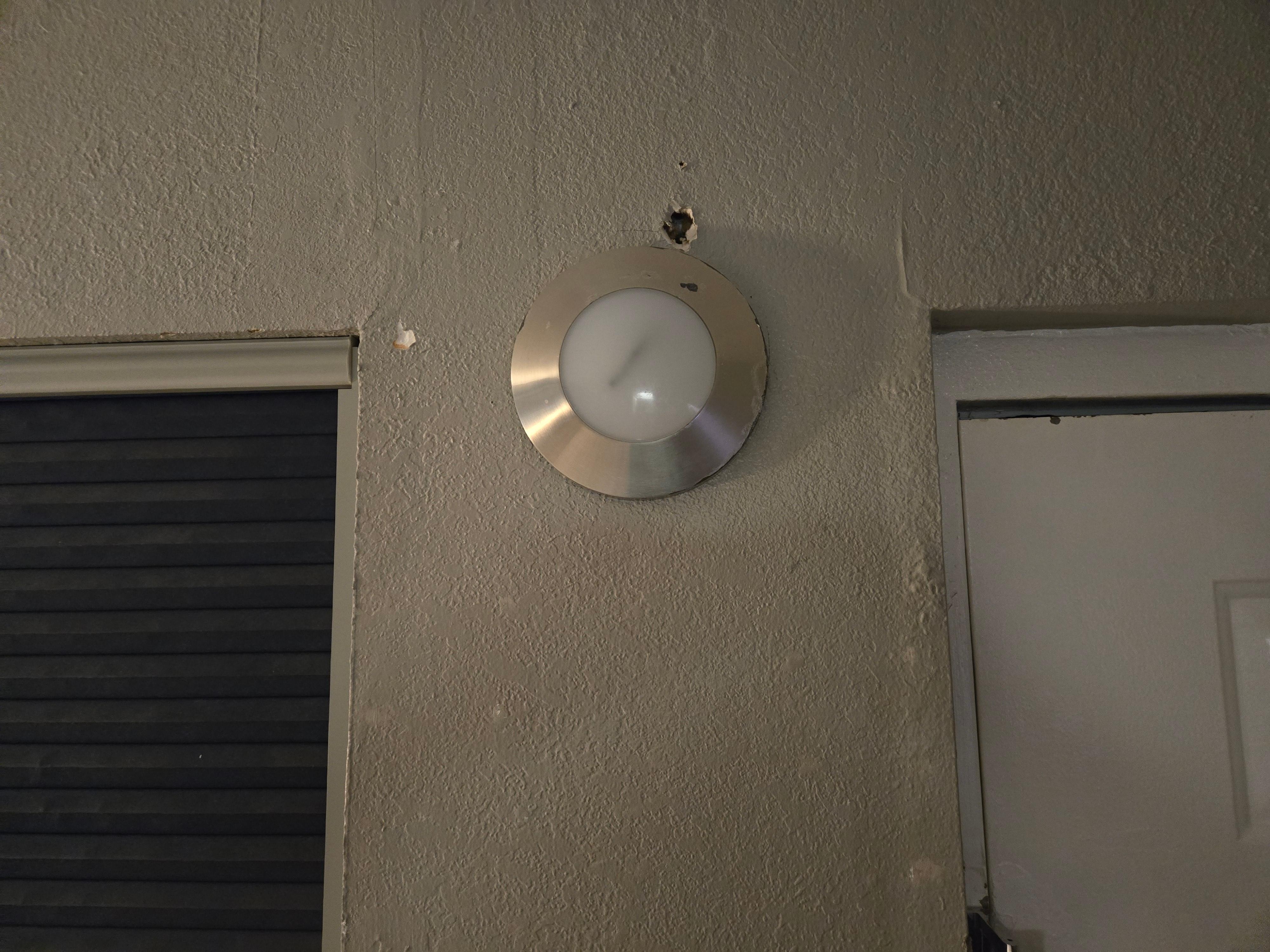 The walls had holes and there was one patch by the bathroom. I opened the door and flipped on the light switch, nothing happened. I had to use my phone's light to get to the other side and turn on the bathroom light. 