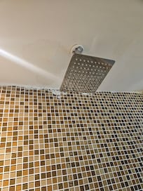 This is in the shower water damage an the patch job look terrible