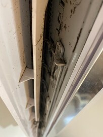 mildew/mold filled AC unit directly above the pillows on the bed