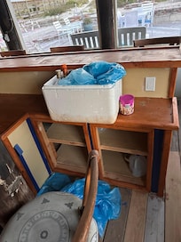 Empty liquor bottles and tarps downstairs