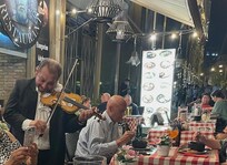 Fiddler entertains in a local restaurant.