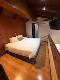 I believe this was a queen or kings size bed, with acá and a big screen tv.