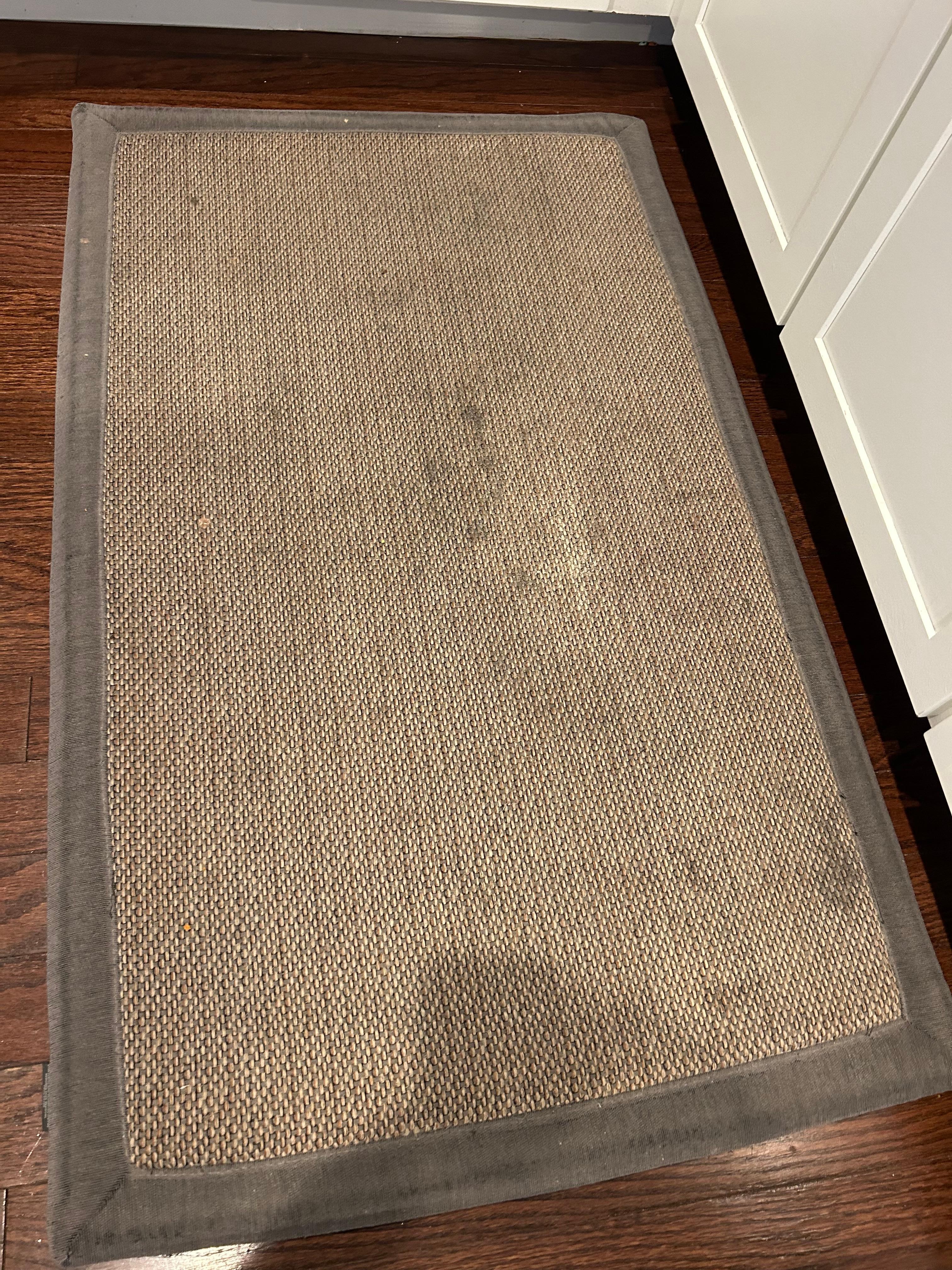 Soiled rug by kitchen sink 
