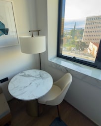 The chair and table by the window.