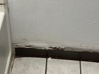 Restroom floor base was falling off.