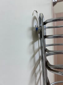 Towel rack falling out of the wall.
