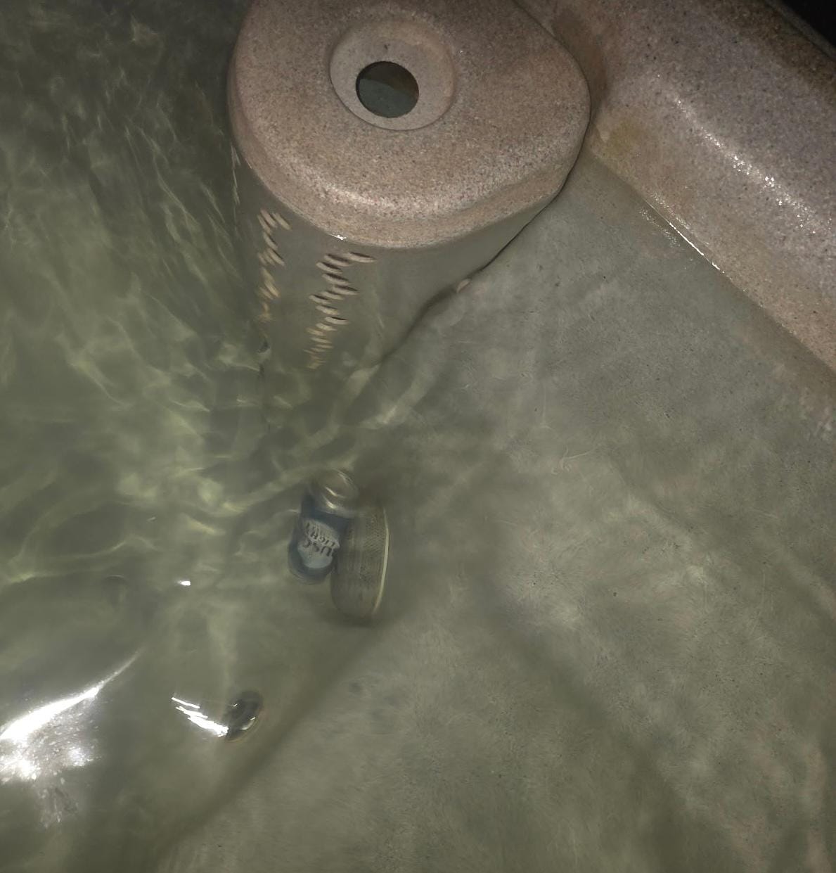 Beer can in the hot tub. 