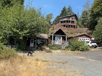 The cabin from the drive way/road to neighbors
