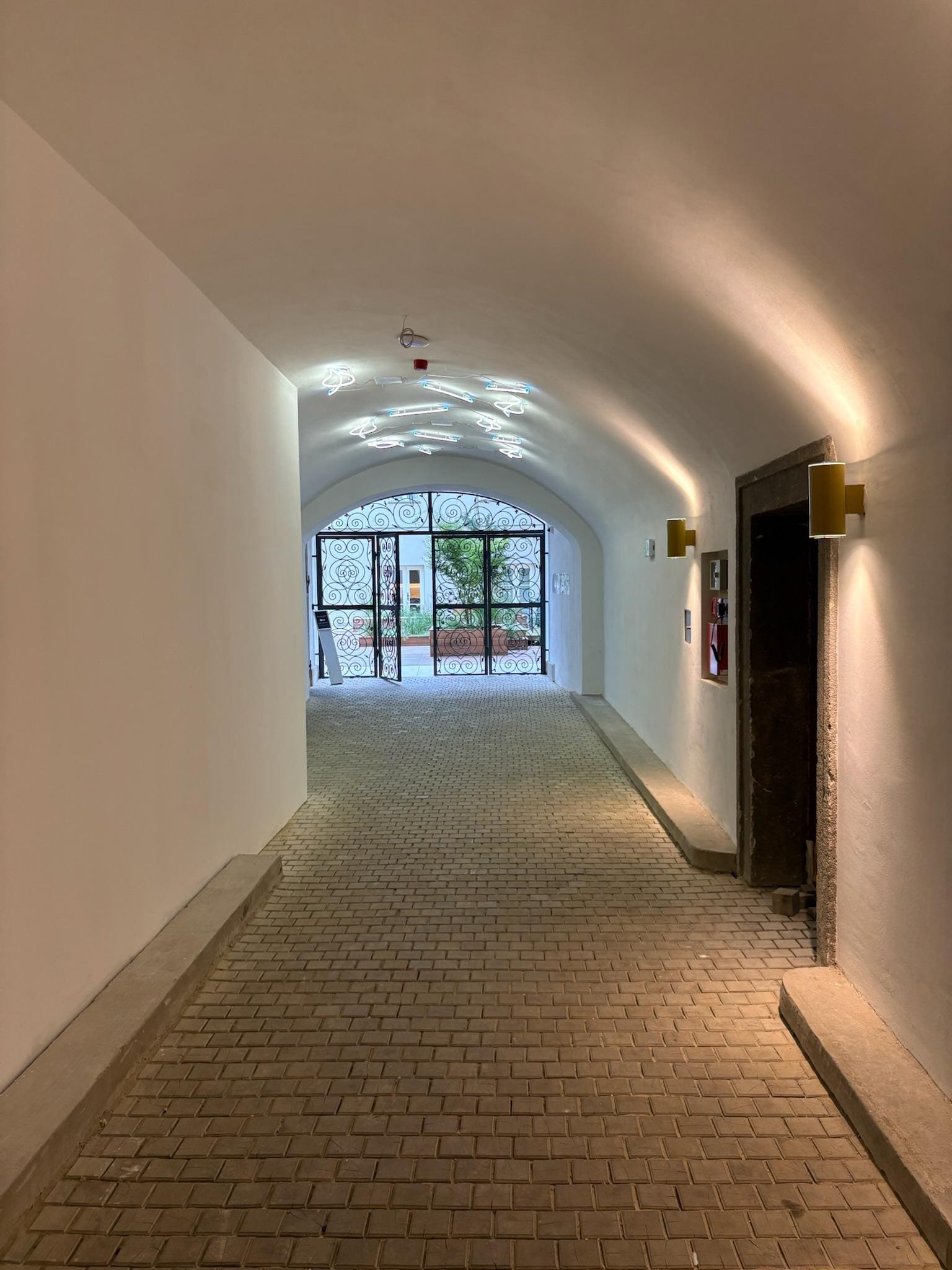 Directly inside the entrance, facing the inside courtyard 