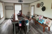 Spacious dining room with very long table and great views out the windows!