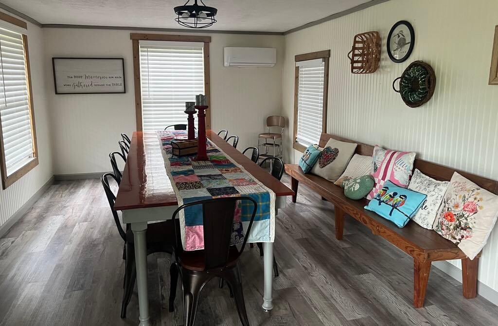 Spacious dining room with very long table and great views out the windows!
