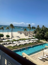 Partial view of the pool, beach and ocean, taken from our room